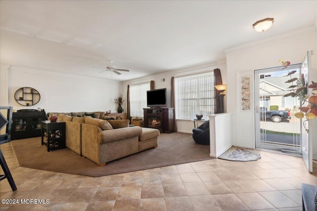 living room with ceiling fan, ornamental molding, and a fireplace