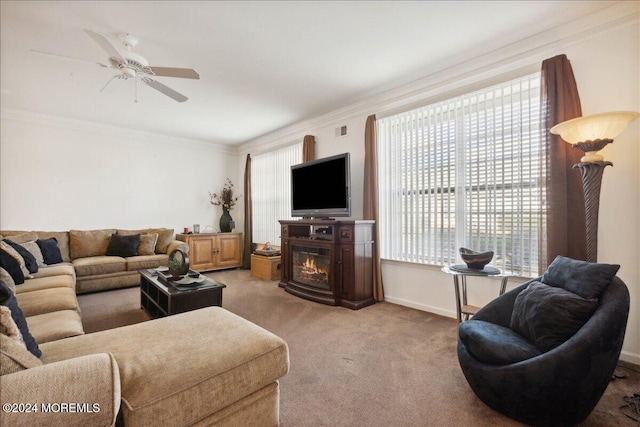 living room with ornamental molding, carpet flooring, and ceiling fan