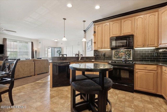 kitchen featuring sink, black appliances, light brown cabinets, backsplash, and hanging light fixtures