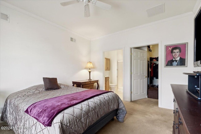 carpeted bedroom with ceiling fan, crown molding, and a closet