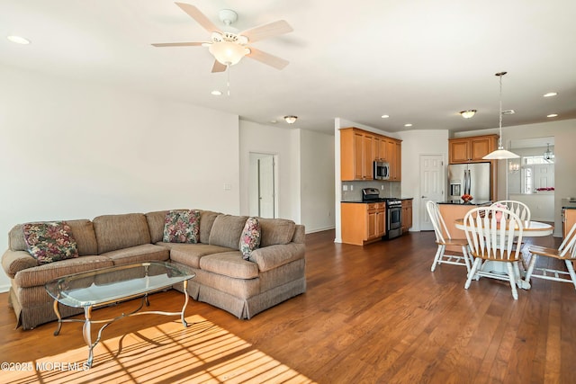 living area with recessed lighting and dark wood-type flooring