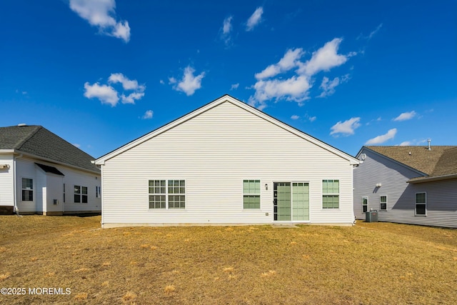 rear view of property with a lawn