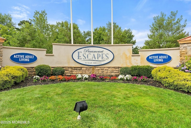 community / neighborhood sign with a lawn