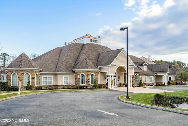 view of building exterior featuring curved driveway