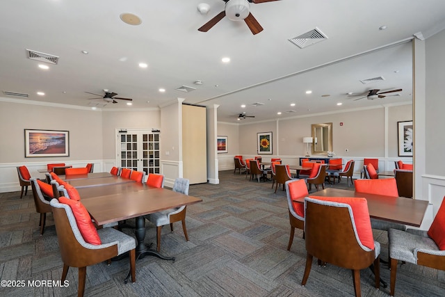 dining area featuring visible vents, ornamental molding, and wainscoting