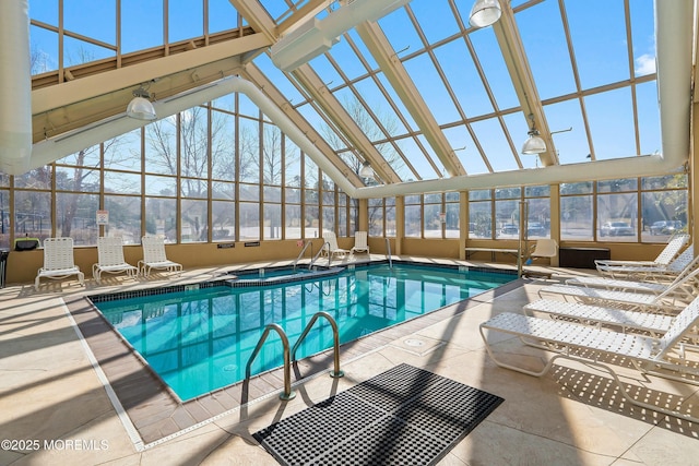 pool featuring a lanai, a patio area, and an indoor hot tub