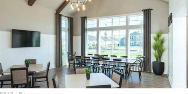 dining space featuring high vaulted ceiling, beamed ceiling, and a chandelier