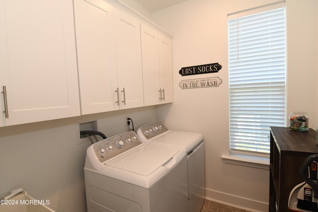 washroom featuring tile patterned flooring, a wealth of natural light, cabinets, and washer and dryer