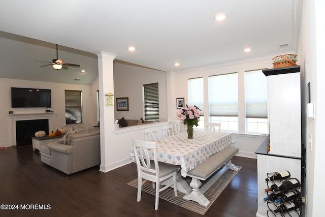 dining space featuring ceiling fan, dark hardwood / wood-style floors, ornate columns, and crown molding