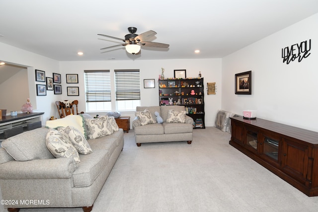 living room with light colored carpet and ceiling fan