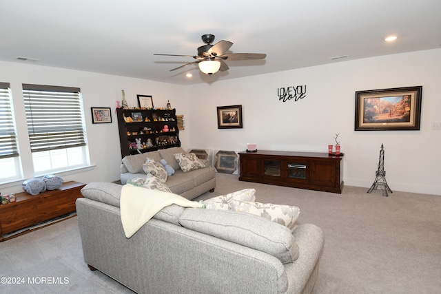 carpeted living room with ceiling fan