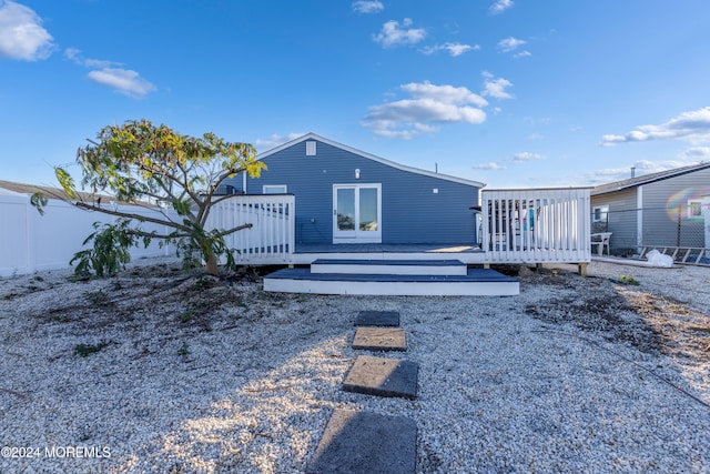 back of property featuring a wooden deck