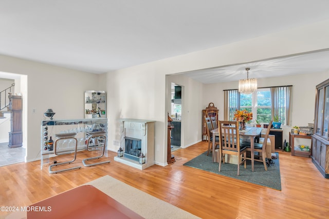 dining room with wood-type flooring and a notable chandelier