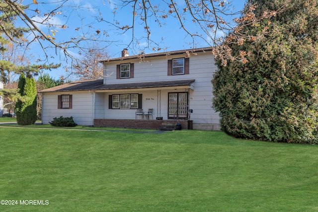 front facade featuring a front lawn and covered porch