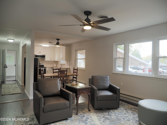 living area featuring ceiling fan and wood-type flooring