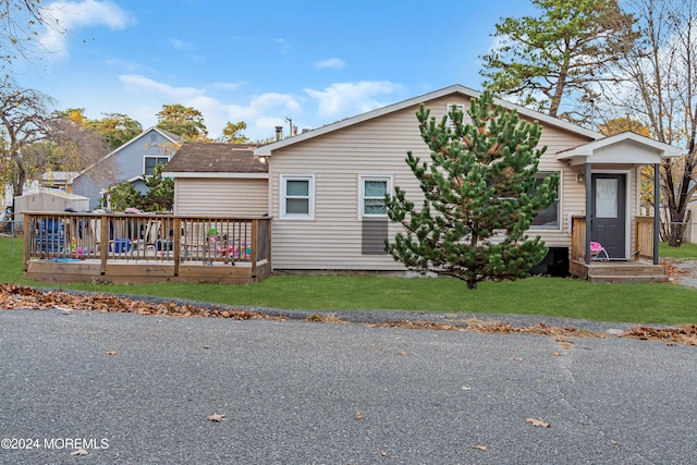 view of front of property with a front lawn and a deck