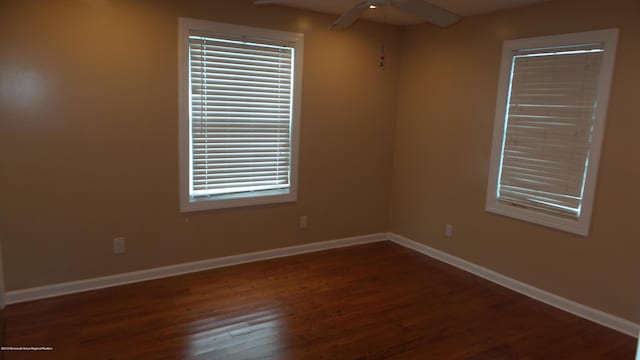 empty room featuring ceiling fan and dark hardwood / wood-style flooring