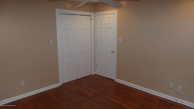 unfurnished bedroom featuring ceiling fan, dark wood-type flooring, and a closet