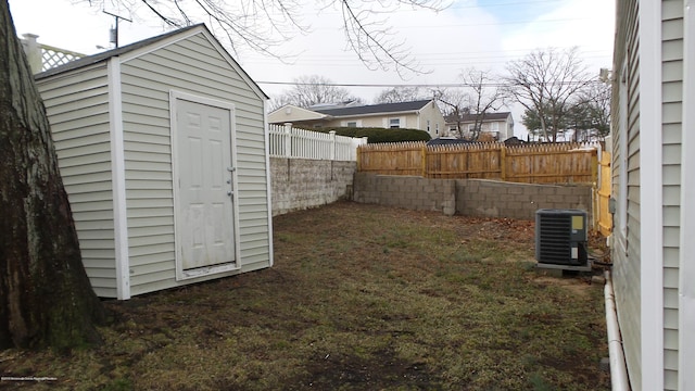 view of yard with a shed and central AC