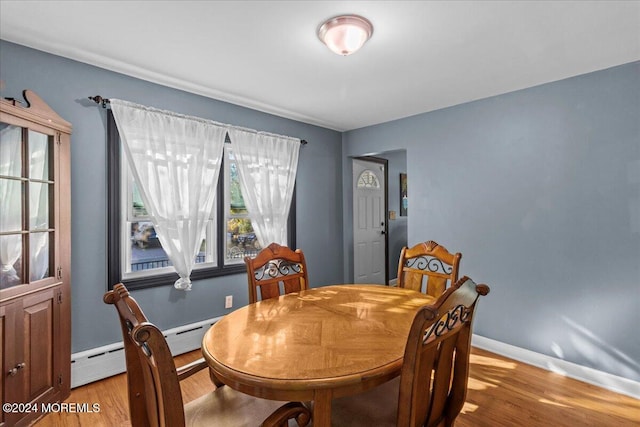 dining area featuring light wood-type flooring and a baseboard radiator