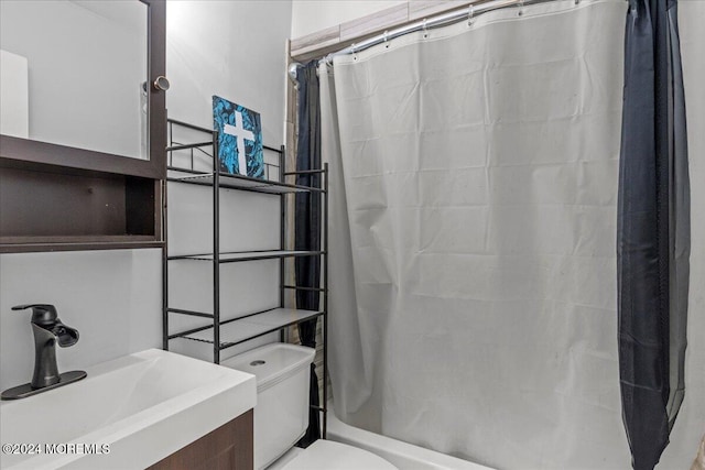 full bathroom featuring shower / bath combo, vanity, and toilet