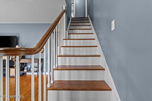 stairs with hardwood / wood-style floors