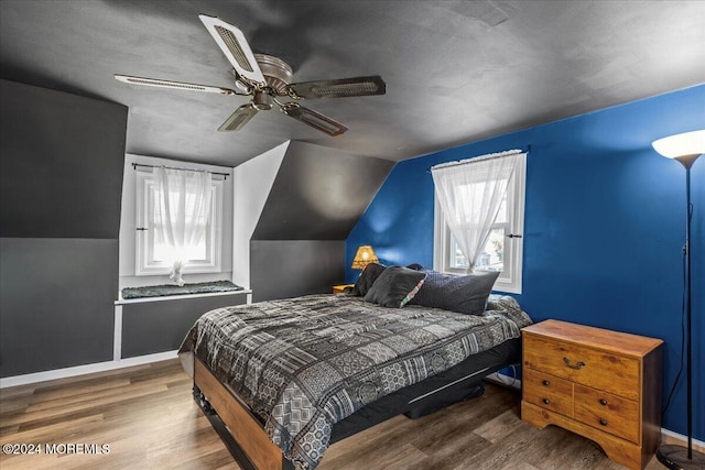 bedroom featuring a textured ceiling, hardwood / wood-style flooring, ceiling fan, and vaulted ceiling