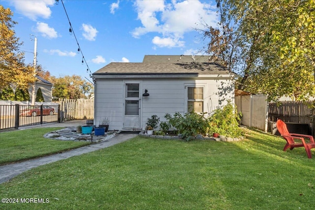 rear view of house with a lawn