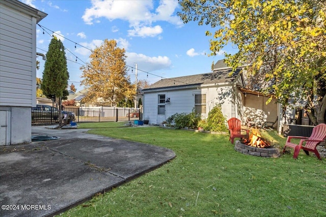 view of yard featuring an outdoor fire pit and a patio area