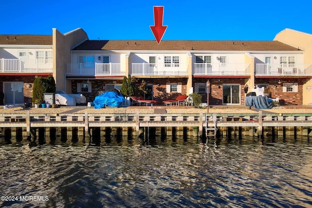 rear view of house featuring a water view