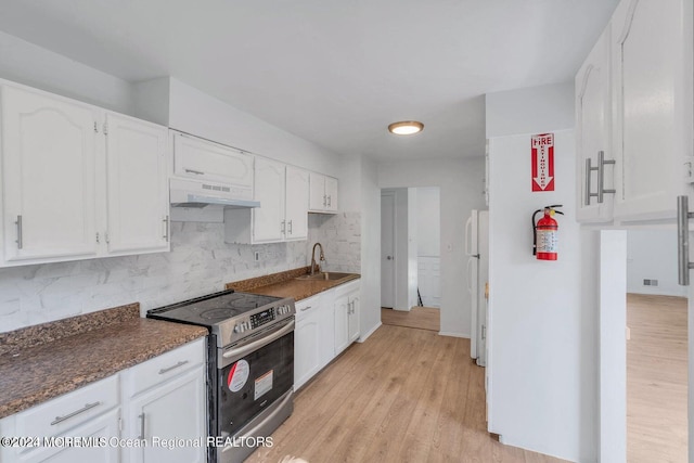 kitchen with white refrigerator, white cabinets, stainless steel range with electric cooktop, ventilation hood, and light hardwood / wood-style flooring