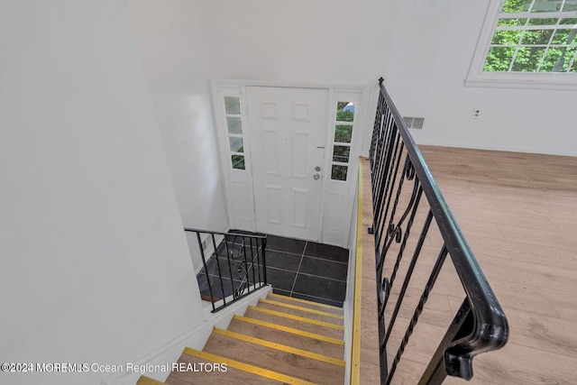 stairs with hardwood / wood-style floors