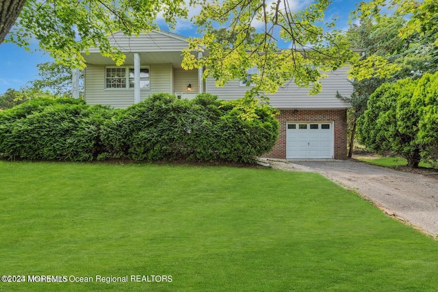 view of front of home with a front lawn and a garage