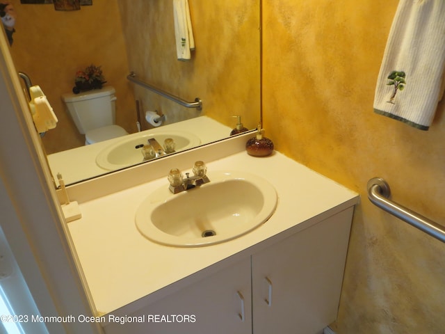 bathroom featuring vanity and toilet