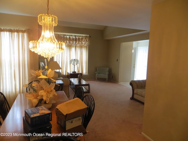 dining room featuring a chandelier, carpet, and baseboards