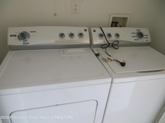 washroom featuring laundry area and separate washer and dryer