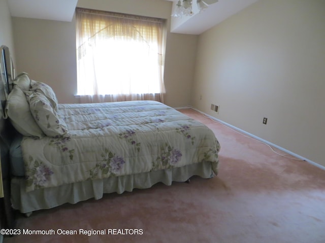 bedroom with carpet, visible vents, and baseboards