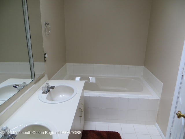 full bathroom with tile patterned flooring, a garden tub, a sink, and double vanity