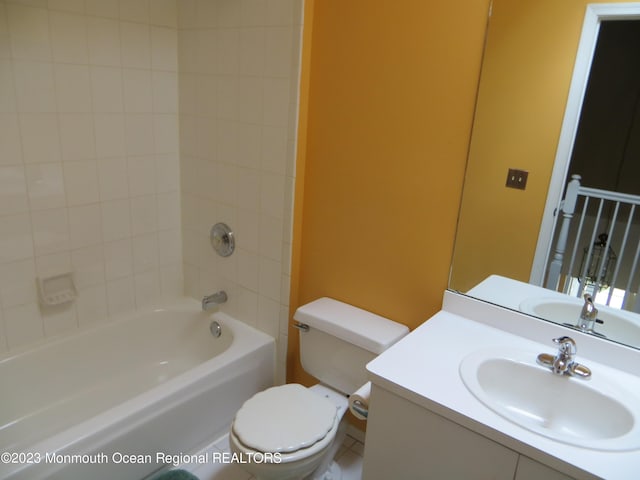 bathroom featuring toilet, shower / bath combination, and vanity