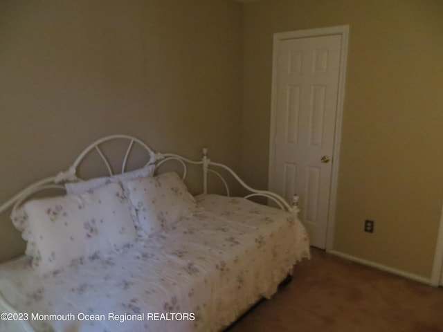 bedroom with carpet flooring and baseboards