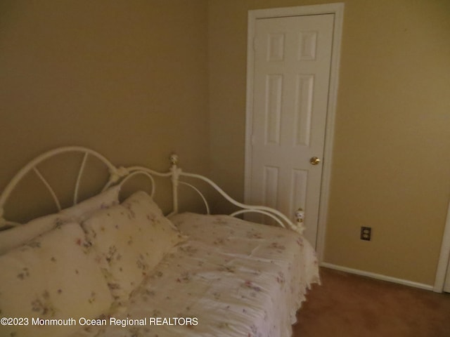 carpeted bedroom featuring baseboards