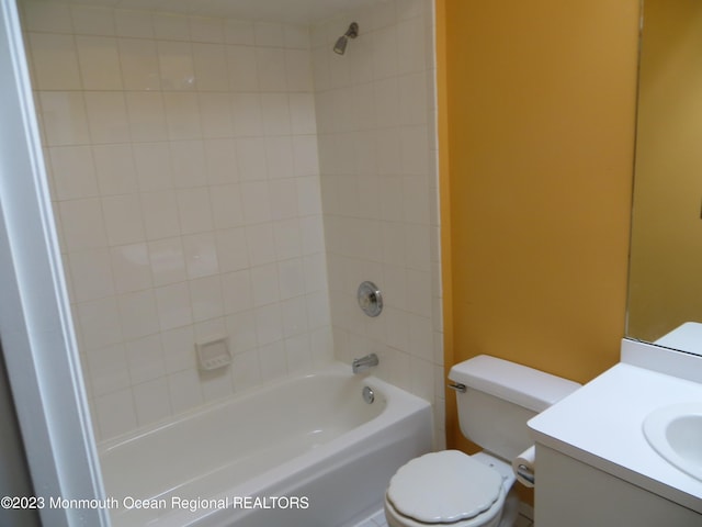 bathroom featuring toilet, washtub / shower combination, and vanity