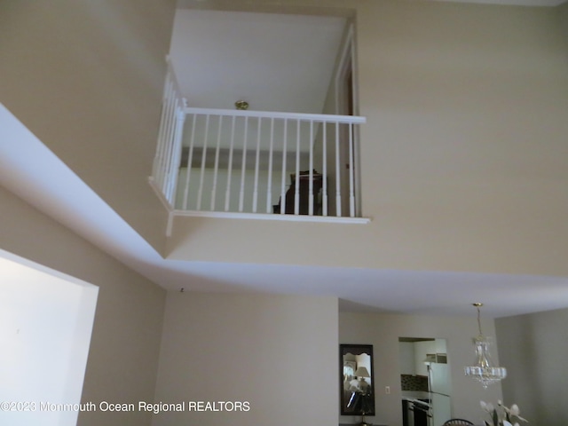 room details featuring an inviting chandelier and freestanding refrigerator