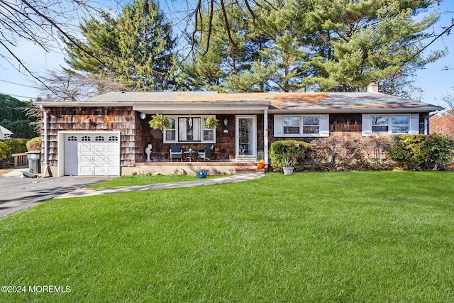 single story home featuring a garage and a front lawn