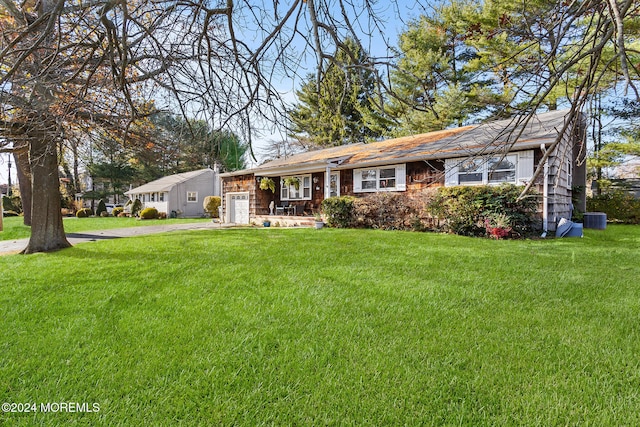 single story home featuring central air condition unit and a front yard