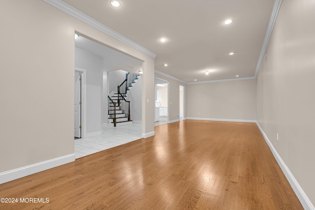 interior space with light wood-type flooring and crown molding