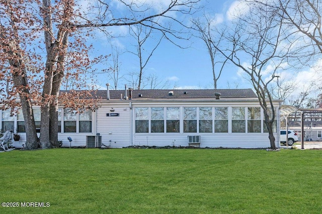 rear view of property with a lawn