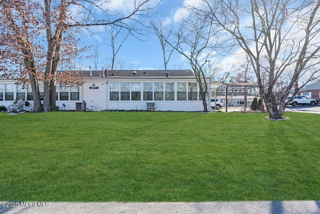 back of house featuring central AC and a yard