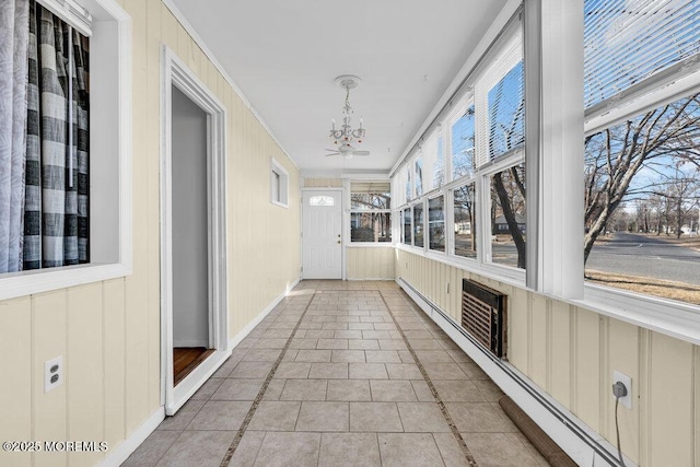 unfurnished sunroom featuring an inviting chandelier