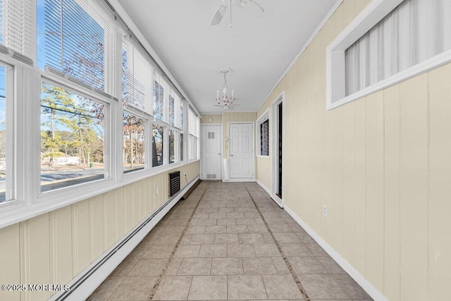 corridor featuring an inviting chandelier, a baseboard radiator, baseboards, and light tile patterned flooring